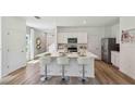 Bright modern kitchen boasts stainless appliances, a large island with seating and white cabinets at 8647 Sw 44Th Ter, Ocala, FL 34476