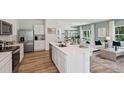 Open-concept kitchen featuring a large island with stainless steel appliances and views of the living area at 8647 Sw 44Th Ter, Ocala, FL 34476