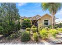 Well-maintained home featuring lush landscaping, decorative bushes, and an inviting entrance at 8650 Sw 83Rd Loop, Ocala, FL 34481