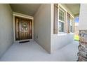 Inviting front porch showcasing a beautifully adorned front door with decorative wreath at 8870 Sw 62Nd Ave, Ocala, FL 34476
