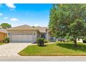 Charming home featuring a two-car garage and a well-manicured lawn on a sunny day at 9628 Sw 90Th St, Ocala, FL 34481
