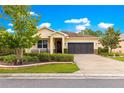 Charming home featuring a two-car garage and lush landscaping at 9642 Sw 95Th Loop, Ocala, FL 34481
