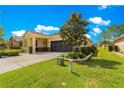 Beautiful single Gathering home featuring a two-car garage and an expansive green lawn at 9642 Sw 95Th Loop, Ocala, FL 34481