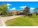 Beautiful single Gathering home featuring a two-car garage and an expansive green lawn at 9642 Sw 95Th Loop, Ocala, FL 34481