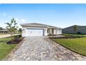 Charming single-story home with manicured lawn, long paver driveway, and inviting front entrance at 10569 Sw 98Th Pl, Ocala, FL 34481