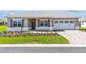 Inviting single-story home boasts a manicured lawn and an elegant brick paver driveway at 10977 Sw 101St Loop, Ocala, FL 34481