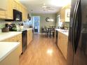 Well-maintained kitchen with wood cabinets, long countertop, and black appliances at 13762 Sw 112Th Ter, Dunnellon, FL 34432