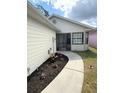 Inviting walkway with a screened porch and flowerbeds, enhancing curb appeal at 2209 Ne 40Th Ave, Ocala, FL 34470