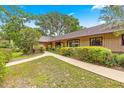 Landscaped front yard with a concrete walkway leading to the entrance of this home at 2416 Se 15Th St, Ocala, FL 34471