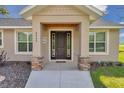 Inviting front entrance with stone pillars, a stylish door, and manicured landscaping, creating a warm welcome at 2525 Sw 7Th Ave, Ocala, FL 34471