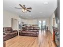 Spacious living room featuring wood-look tile flooring, a ceiling fan, and an open concept design at 2525 Sw 7Th Ave, Ocala, FL 34471