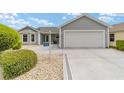Charming single-story home featuring a bay window, lovely landscaping, and a two-car garage at 2608 Casso Ct, The Villages, FL 32162