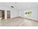 Inviting living room with new floors and a large window offering ample natural light at 3224 Sw 149 Ter, Ocala, FL 34481