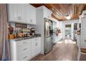 Beautiful white kitchen featuring modern appliances, wooden ceiling, and coffee bar setup at 3299 County Road 521, Wildwood, FL 34785