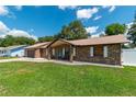 Charming brick home with a well-maintained lawn, covered porch, and attached garage at 3881 Se 61St Pl, Ocala, FL 34480