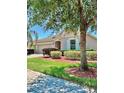 Attractive single-story home boasts manicured lawn and updated landscaping at 5009 Neptune Cir, Oxford, FL 34484