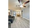 Spacious living room and dining room featuring wood-look tile flooring and modern lighting at 5009 Neptune Cir, Oxford, FL 34484