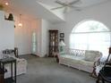 Bright living room with tall ceilings, decorative windows, and ample seating for a warm and inviting space at 5391 Nw 19Th Pl, Ocala, FL 34482