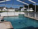 Relaxing screened-in pool area features a sparkling pool with an attached spa, perfect for outdoor enjoyment at 5391 Nw 19Th Pl, Ocala, FL 34482