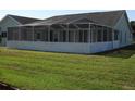 Spacious screened-in porch area overlooking a lush green lawn, ideal for entertaining or relaxing in the outdoors at 5391 Nw 19Th Pl, Ocala, FL 34482