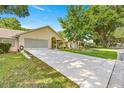 Single story home with a well maintained lawn and long driveway for easy access at 8710 Sw 91St St # E, Ocala, FL 34481
