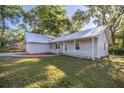Single-story home with a metal roof, gray siding and front porch at 9 Juniper Pass Trl, Ocala, FL 34480
