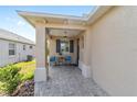 Inviting front porch featuring stylish patio furniture and a hanging lantern, creating a cozy outdoor space at 9309 Sw 106Th Ave, Ocala, FL 34481