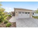 Two-car garage featuring a brick-paved driveway, enhancing the curb appeal of the home at 9309 Sw 106Th Ave, Ocala, FL 34481