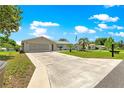 Single-story home featuring a spacious driveway, well-kept lawn, and serene landscaping for a peaceful setting at 11237 Sw 78Th Ct, Ocala, FL 34476