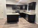 This kitchen features dark wood cabinets, stainless steel appliances, and granite countertops at 12472 Se 67Th Terrace Rd, Belleview, FL 34420