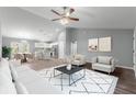 Bright living room featuring modern furnishings and seamlessly connecting to the kitchen and dining area at 12472 Se 67Th Terrace Rd, Belleview, FL 34420