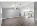 Light-filled living space with vaulted ceiling and hardwood floors, offering a spacious and welcoming atmosphere at 12472 Se 67Th Terrace Rd, Belleview, FL 34420