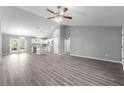 Spacious open-concept living area with high ceilings and contemporary flooring, leading into kitchen at 12472 Se 67Th Terrace Rd, Belleview, FL 34420