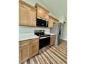 Bright kitchen featuring stainless steel appliances, sleek countertops, and ample wooden cabinet space at 13303 Sw 106Th Pl, Dunnellon, FL 34432