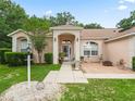 Charming exterior showcases a well-maintained facade with brick accents, manicured landscaping, and inviting entrance at 16 Count Fleet Dr, Ocala, FL 34482