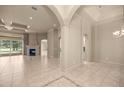 Spacious living room featuring a fireplace, archways and a view to the pool area at 1675 Se 73Rd Pl, Ocala, FL 34480