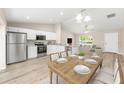 Bright kitchen with stainless steel appliances, white cabinets, granite countertops and adjacent dining area at 21301 Sw Rainbow Lakes Blvd, Dunnellon, FL 34431
