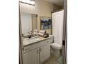 Bathroom featuring a granite countertop, vanity with storage, and shower with a curtain at 2215 Ne 16Th Ct, Ocala, FL 34470