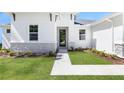 Close up of the front door of a charming one-story home with manicured lawn at 2254 Amberly Ave, Orlando, FL 32833