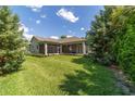 Expansive backyard with lush green lawn, mature landscaping and screened in patio at 2417 Se 23Rd St, Ocala, FL 34471