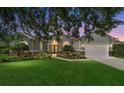Charming home with a well-manicured lawn and stone accents beneath the windows during twilight at 2417 Se 23Rd St, Ocala, FL 34471