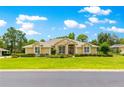 Beautiful single-story home with manicured lawn, lush landscaping, and a welcoming facade at 28 Golf View Dr, Ocala, FL 34472