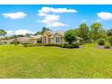 Attractive single-story house with expansive lawn and mature trees at 28 Golf View Dr, Ocala, FL 34472