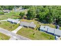 Aerial view of home with metal roof, nestled on a lush, green lot in a quiet neighborhood at 2981 Ne 39Th Pl, Ocala, FL 34479
