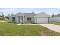 Charming one-story home with a well-manicured lawn and attached two-car garage at 3079 Sw 168 Pl, Ocala, FL 34473