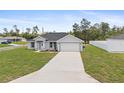 Well-maintained home with a lush front lawn and a spacious concrete driveway at 3079 Sw 168 Pl, Ocala, FL 34473