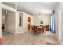 Open-concept dining room with view to the kitchen featuring tile floors and natural light at 3102 Ne 26Th St, Ocala, FL 34470