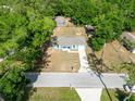 A high angle view of the blue house with a large front yard and driveway at 5193 Nw 61St Ave, Ocala, FL 34482