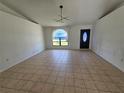 Spacious living room with neutral tile floors, a large front window, and recessed lighting at 6 Bahia Trace Loop, Ocala, FL 34472