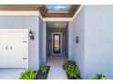 Inviting front entrance featuring a covered porch, decorative details, and access to the home's interior at 6046 Sw 86Th Cir, Ocala, FL 34481